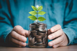jar with plant growing in money