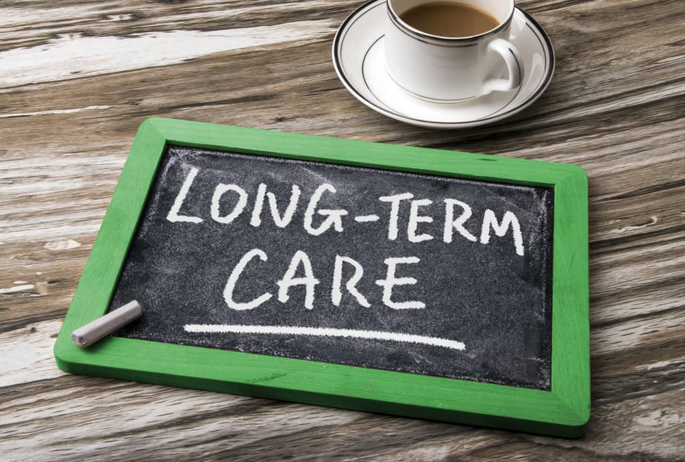 long-term care handwritten on blackboard